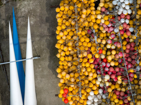Aerial view of a large collection of colorful yellow, white, and red buoys arranged on a concrete surface alongside long, pointed white and blue structures in Belgrade, City of Belgrade, Serbia.