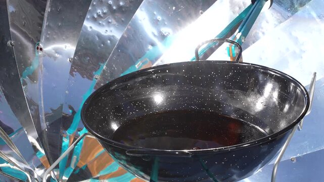 Cooking Oil Heating in Solar Cooker Pan Under Bright Sunlight