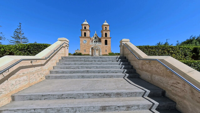 View of St Francis Xavier's Cathedral seen from the stone steps under a clear blue sky in Geraldton, Western Australia, Australia.