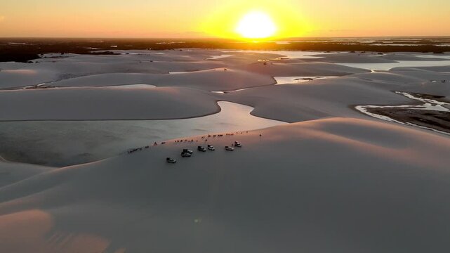 Aerial view of Parque Nacional dos Lencois Maranhenses with sand dunes and lagoons at sunset in MA, Brazil.