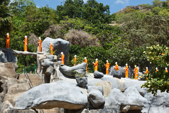 Scene featuring buddhist monk statues at Golden Temple, Dambulla, Sri Lanka