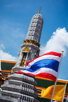 Thailand flag alongside Buddhist temple Wat Pho. Bangkok, Thailand