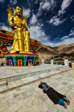 A tibetan Buddhist woman worshiping and praying Buddha Maitreya statue in Likir gompa (monastery), Ladakh, India