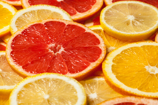 Colorful citrus fruit - lemon, orange, grapefruit - slices backdrop