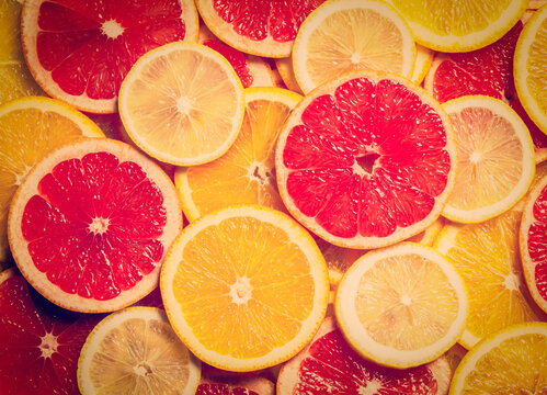 Vintage retro effect filtered hipster style scene of colorful citrus fruit - lemon, orange, grapefruit - slices background