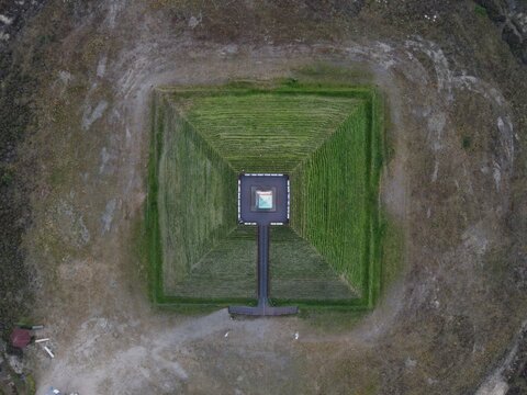 Netherlands - 12 July 2026: Aerial view of the Pyramid of Austerlitz, a historic monument with a stone obelisk at its peak, surrounded by grassy slopes and a wooden walkway.