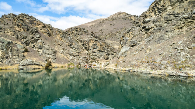 Aerial view of the turquoise waters of the Kawarau River flowing through the rugged rocky gorge in Cromwell, Otago Region, New Zealand.