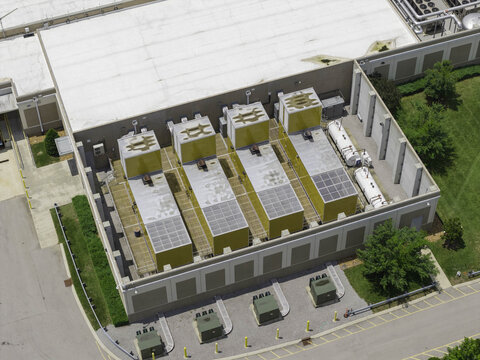 Aerial view of a data center mechanical yard featuring large yellow standby diesel generators, fuel tanks, and industrial infrastructure in Franklin, Tennessee, United States.