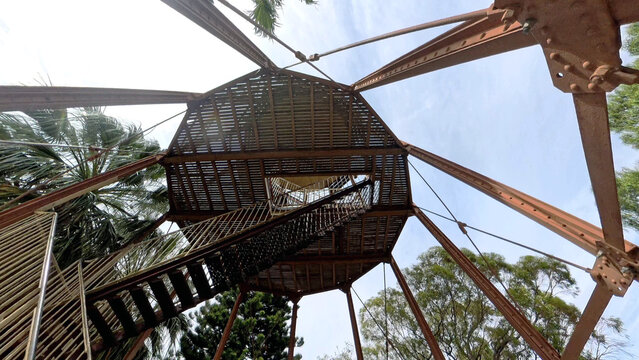 View of the metal structure and stairs of the Water Tower Lookout surrounded by palm trees under a clear blue sky in Port Augusta West, South Australia, Australia.