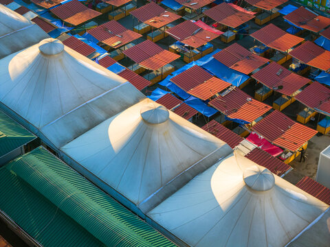 Aerial view of the market featuring white conical tent roofs and rows of red-roofed stalls in Belgrade, City of Belgrade, Serbia.