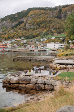 Idyllic Norwegian village nestled by a fjord with autumn foliage