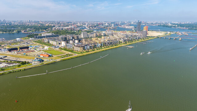 Aerial view of the modern residential district of IJburg, featuring contemporary architecture, waterfront apartments, and bridges spanning the IJ lake in Amsterdam, North Holland, Netherlands.