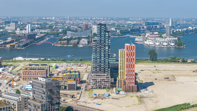 Aerial view of modern high-rise residential towers and urban development along the river IJ in Amsterdam, North Holland, Netherlands.