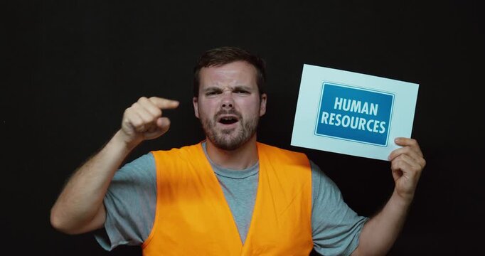 Employee holding a "Human Resources" sign while pointing angrily toward the camera. Ideal for HR conflicts, workplace disputes, employee complaints, disciplinary meetings, and corporate communication 