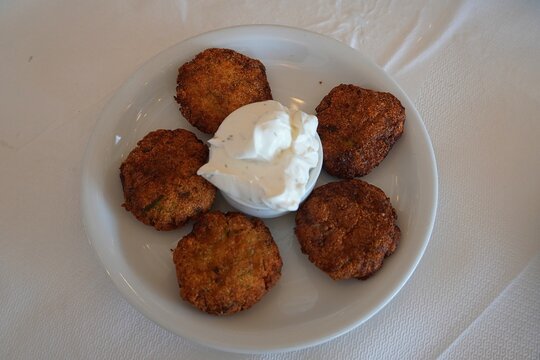 Fried zucchini patties or courgette balls and yogurt dip