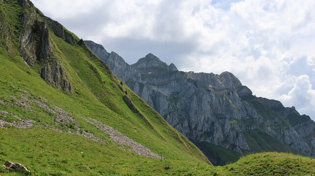 View of the Cornettes de Bise mountain peak rising above lush green alpine slopes and rocky cliffs La Chapelle-d'Abondance, Auvergne-Rhone-Alpes, France.