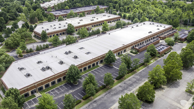 Aerial view of a data center facility featuring rows of air-cooled dry coolers on the roof and surrounding parking lots in Nashville, TN, United States.