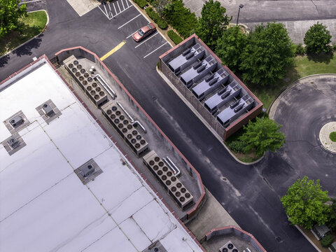 Aerial view of electrical transformer unit substation assemblies and cooling system at a data center with industrial rooftop HVAC units and surrounding parking lot in Nashville, TN, United States.