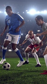 Soccer Player Dribbling Past Two Defenders