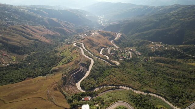 Aerial view of the winding mountain road through the lush, hilly landscape of Colonia Tovar, Caracas, Miranda, Venezuela.