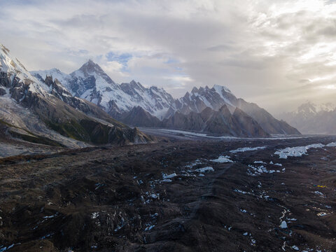Aerial view of Goro II campsite situated on the rocky Baltoro Glacier surrounded by dramatic snow-capped peaks in the Karakoram range in Goro II, Gilgit Baltistan, Pakistan.