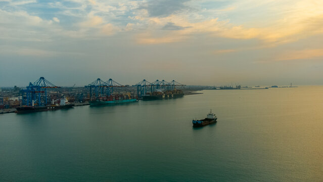 Aerial view of MPS Terminal 3 at the port with large container ships and cranes under a soft sunset sky in Accra, Greater Accra, Ghana.