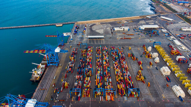 Aerial view of MPS Terminal 3 with rows of colorful shipping containers, large gantry cranes, and a cargo ship docked at the port in Accra, Greater Accra, Ghana.