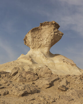 View of the Zekreet Rock Formation, a unique limestone mushroom-shaped rock structure set against a clear blue sky in the desert landscape of Zekreet, Al Sheehaniya Municip, Qatar.