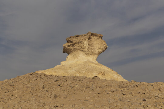View of the unique Zekreet Rock Formation standing in the desert landscape under a cloudy sky in Zekreet, Al Sheehaniya Municip, Qatar.