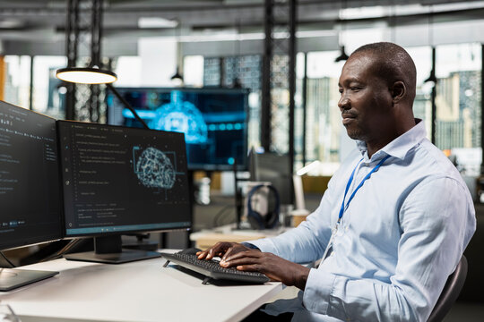 System administrator uses AI scripts on a computer to automate repetitive tasks, applying artificial intelligence technology to accelerate feature implementation and improve productivity in an office.