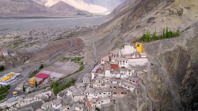 Aerial view of Diskit Monastery nestled on a rocky hillside overlooking the valley in Diskit, Ladakh, INDIA.