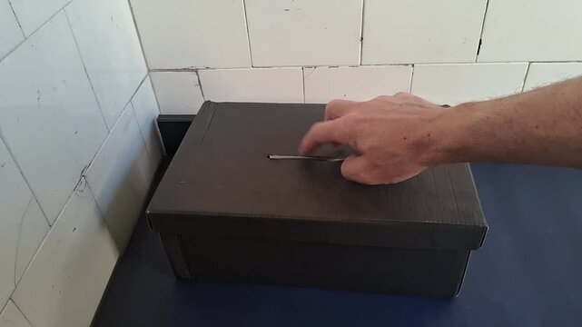 Person casting vote in cardboard ballot box video motion clip