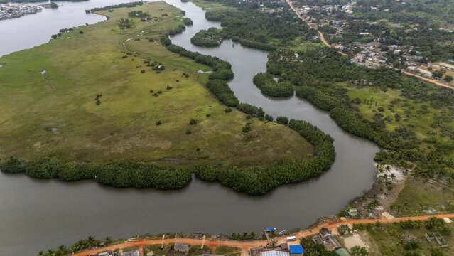 Aerial view of the Gogotinkpon area with a winding river surrounded by lush green vegetation and mangroves Kpomasse, Mono, Benin.