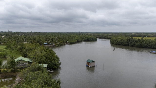 Aerial view of the stilt village of Gogotinkpon surrounded by lush mangroves and calm river waters in Kpomasse, Mono, Benin.