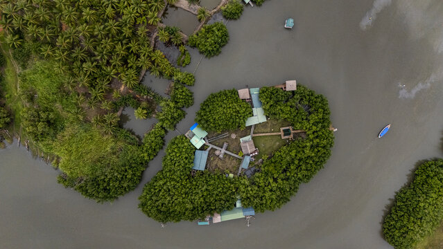 Aerial view of Gogotinkpon, a unique village settlement surrounded by lush mangroves and palm trees in the middle of the lake in Kpomasse, Mono, Benin.