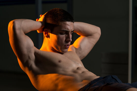 Young Man Working Out With An Exercise Ball