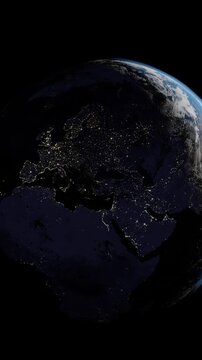 Europe at night from space, Italy, Spain, Portugal, United Kingdom. Vertical video slow zoom into a slow rotating planet Earth.	
