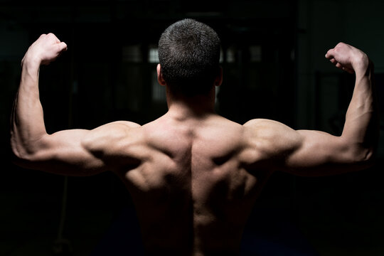 Young Male Athlete Flexing Back Muscles