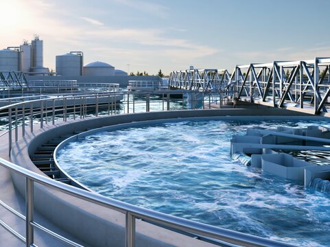 Secondary wastewater clarifier with covered launders and handrail in operational setting during daytime