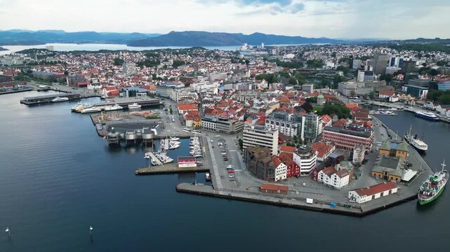 Aerial view of Stavanger harbor and city center with historic buildings, boats docked at the waterfront, and urban landscape in Stavanger, Rogaland, Norway.