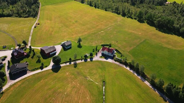 Aerial view of rural farmhouses and green fields in the countryside of Klakegg, Vestland, Norway.