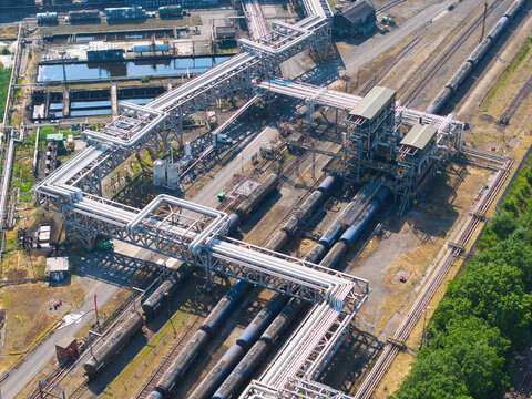 Aerial view of the Humber Refinery chemical plant featuring extensive industrial piping networks, rail tanker cars on tracks, and storage facilities in South Killingholme, England, United Kingdom.