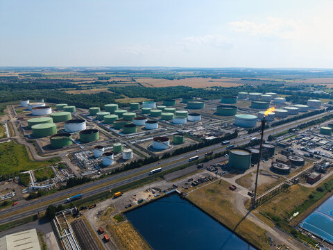 Aerial view of the Humber Refinery chemical plant with large storage tanks and a flare stack, situated near industrial infrastructure, South Killingholme, England, United Kingdom.