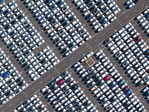 Aerial view of the BCA Kia car distribution service facility featuring rows of parked vehicles organized in a large paved storage lot in Stallingborough, England, United Kingdom.