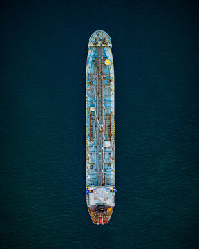 Aerial view of a large tanker ship navigating the waters near the Port of Santo Domingo, Santo Domingo, Distrito Nacional, Dominican Republic.