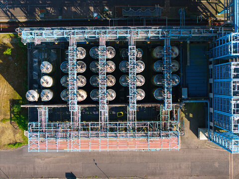 Aerial view of the Humber Innovation Park industrial facility featuring rows of large cylindrical storage tanks and complex metal piping infrastructure in Grimsby, England, United Kingdom.