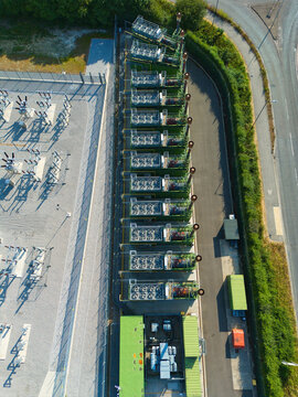 Aerial view of an electrical substation and a row of containerized industrial generator compressor units in Immingham, England, United Kingdom.