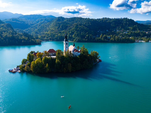 Aerial view of Lake Bled with the Pilgrimage Church of the Assumption on the island, surrounded by lush green forests and turquoise water, Bled, Radovljica, Slovenia.