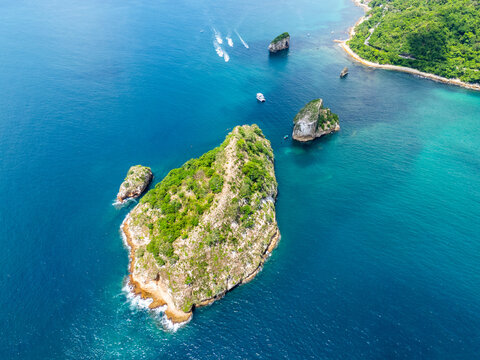 Aerial view of Parque Nacional Marino Los Arcos de Mismaloya with lush green rocky islands surrounded by turquoise waters and boats near the coast in Puerto Vallarta, Jalisco, Mexico.