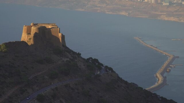 Aerial view of Fort Santa Cruz overlooking the Mediterranean Sea and the long breakwater in Oran, Oran Province, Algeria.